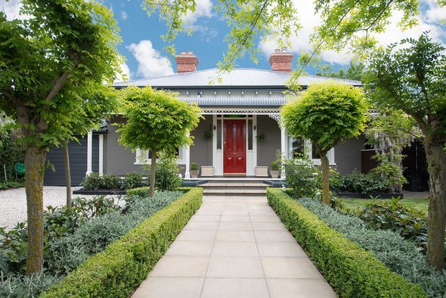 A house with a red door and a walkway leading to it