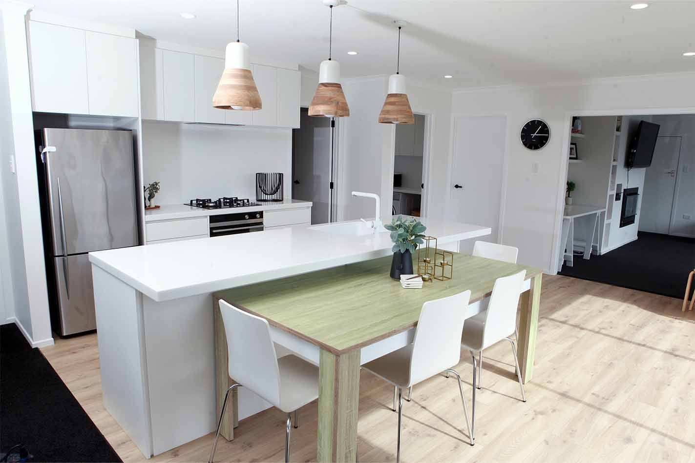 A kitchen with a dining table and chairs in it.