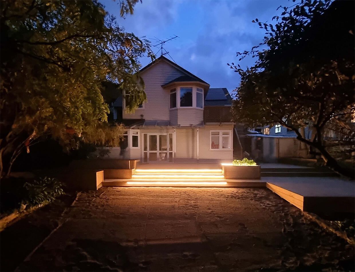 A house with stairs that are lit up at night