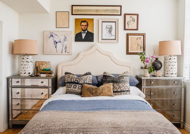 A bedroom with a bed dresser and lamps