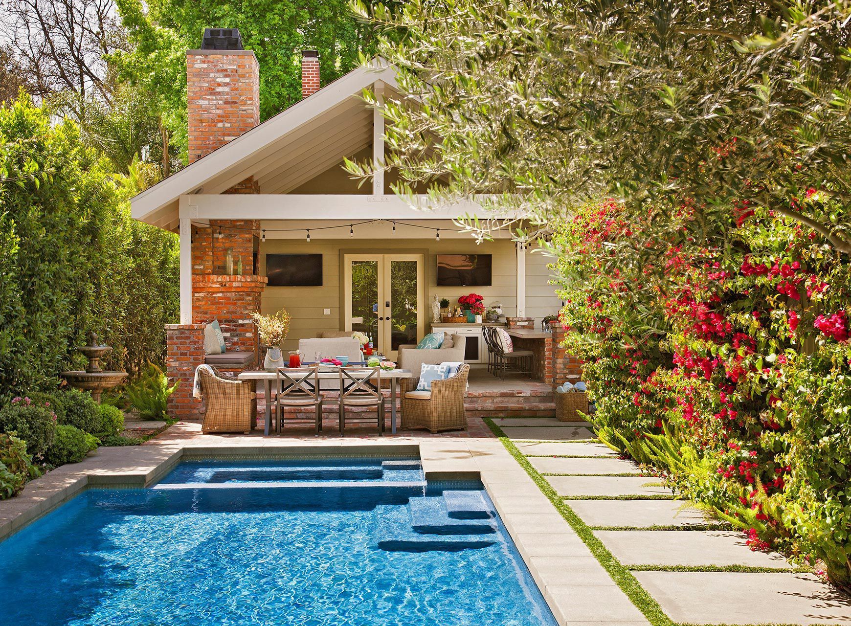 A house with a swimming pool in front of it