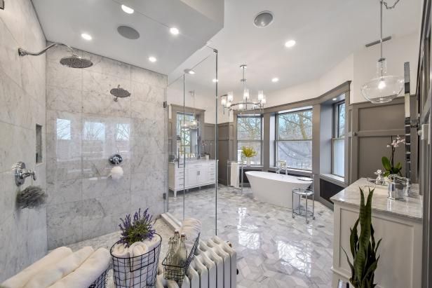 A bathroom with a walk in shower , tub , sink , and window.