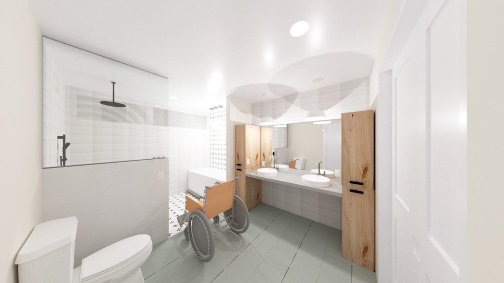 A bathroom with a toilet , sinks , and a wheelchair.
