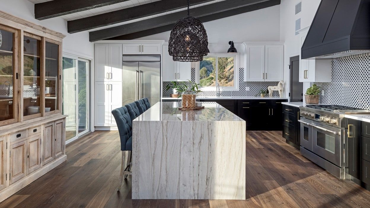 There is a large island in the middle of the kitchen.