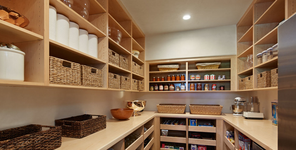 A pantry filled with lots of shelves and baskets.