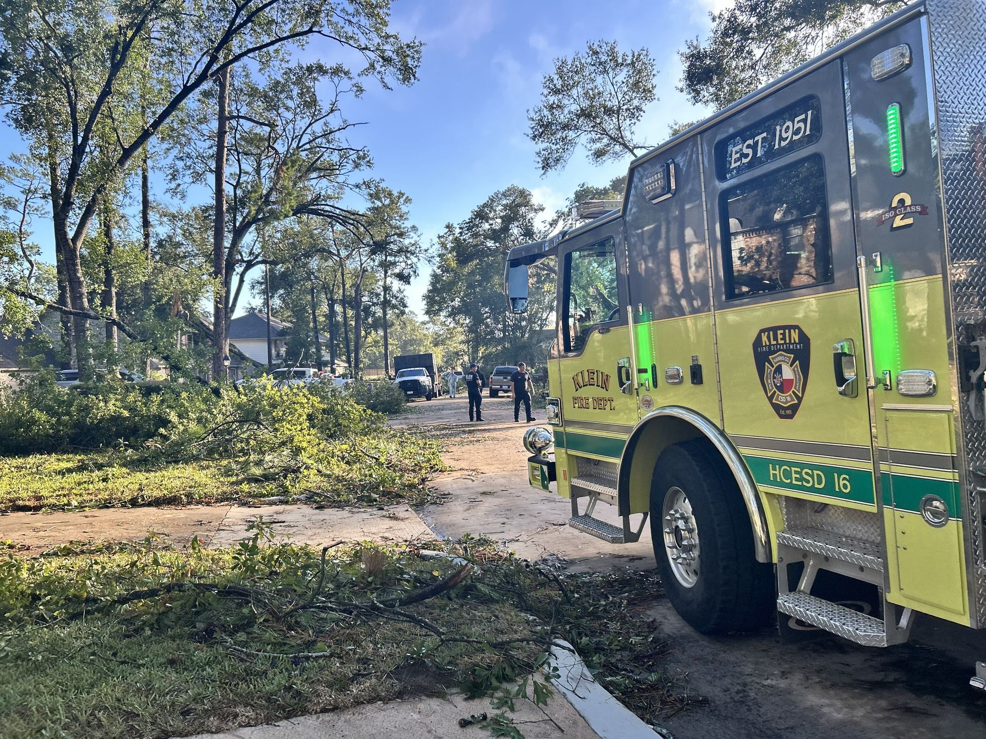 Klein Fire Department Apparatus with tree limbs on street.