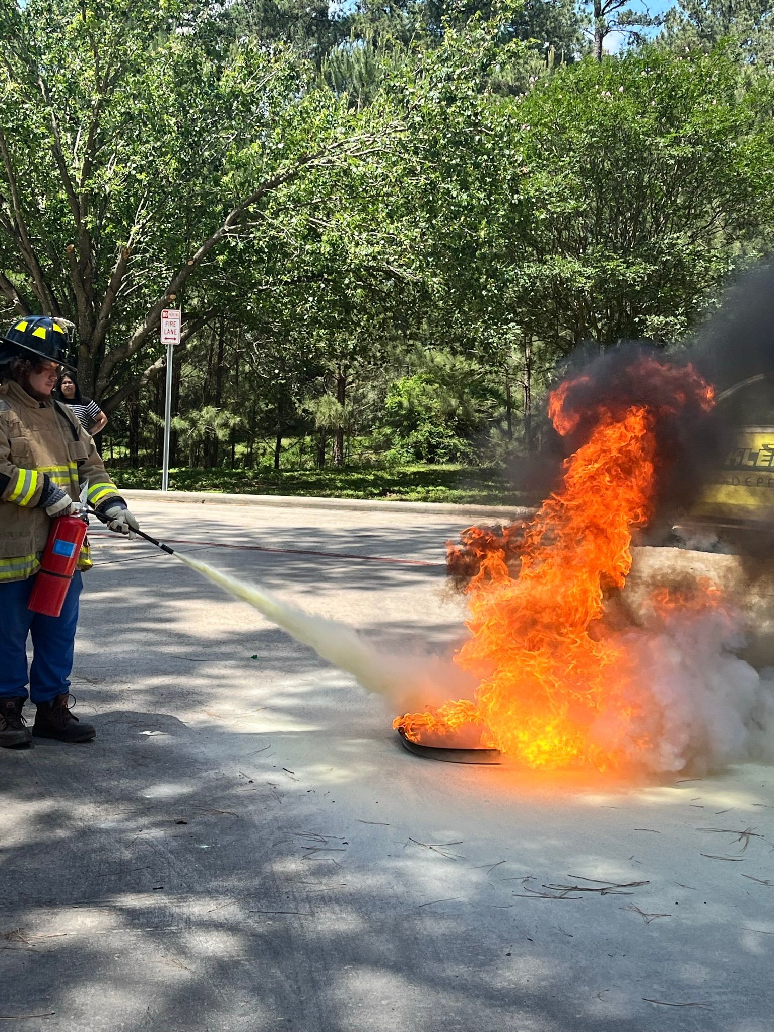 A fireman is using a hose to put out a fire.