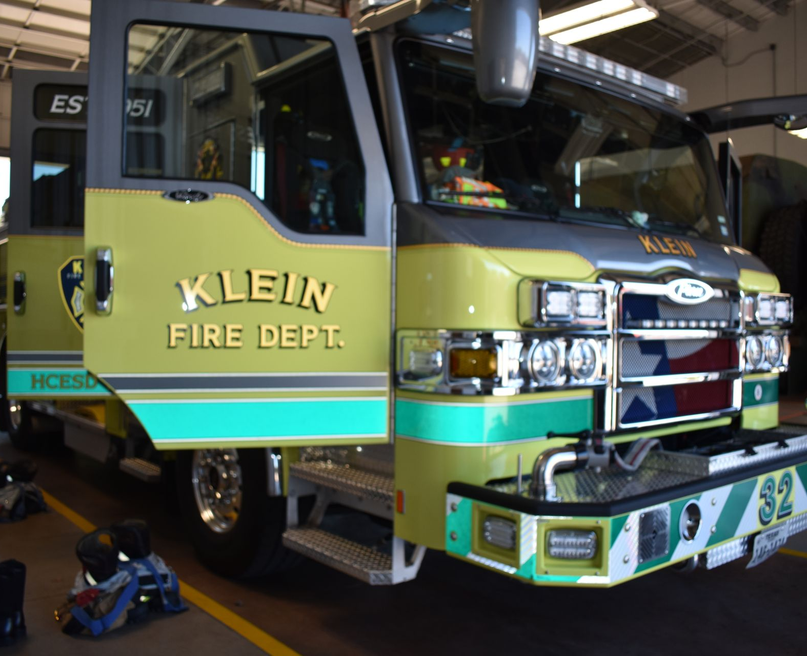 Klein Fire Dept. fire truck in a station, yellow-green with chrome front and emergency lights