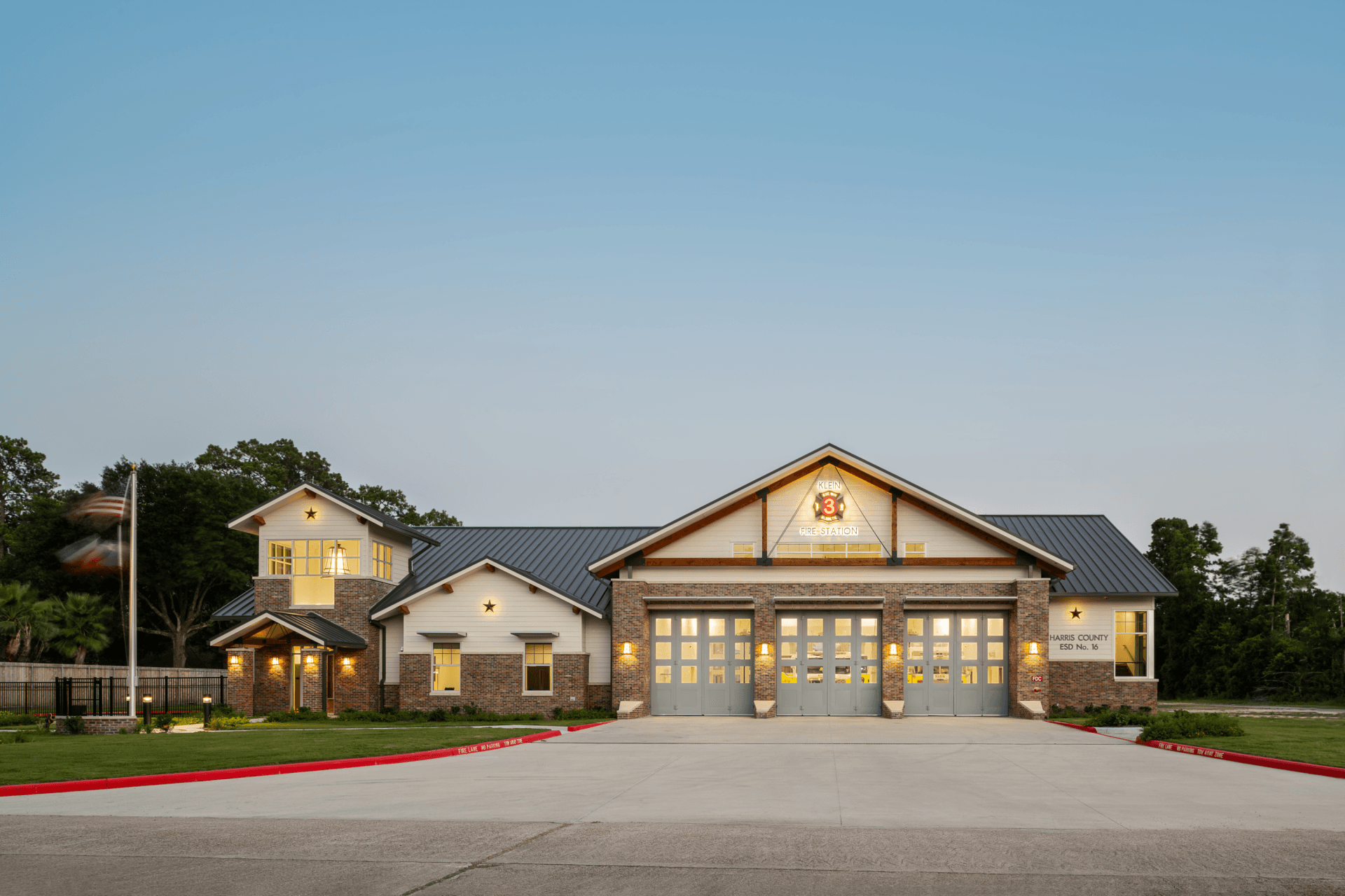 A picture of a fire station in front of it.