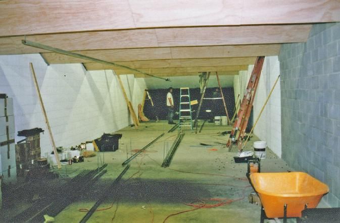 A wheelbarrow sits in the middle of a building under construction