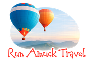 Two colorful hot air balloons above mountains with the text “Run Amuck Travel”
