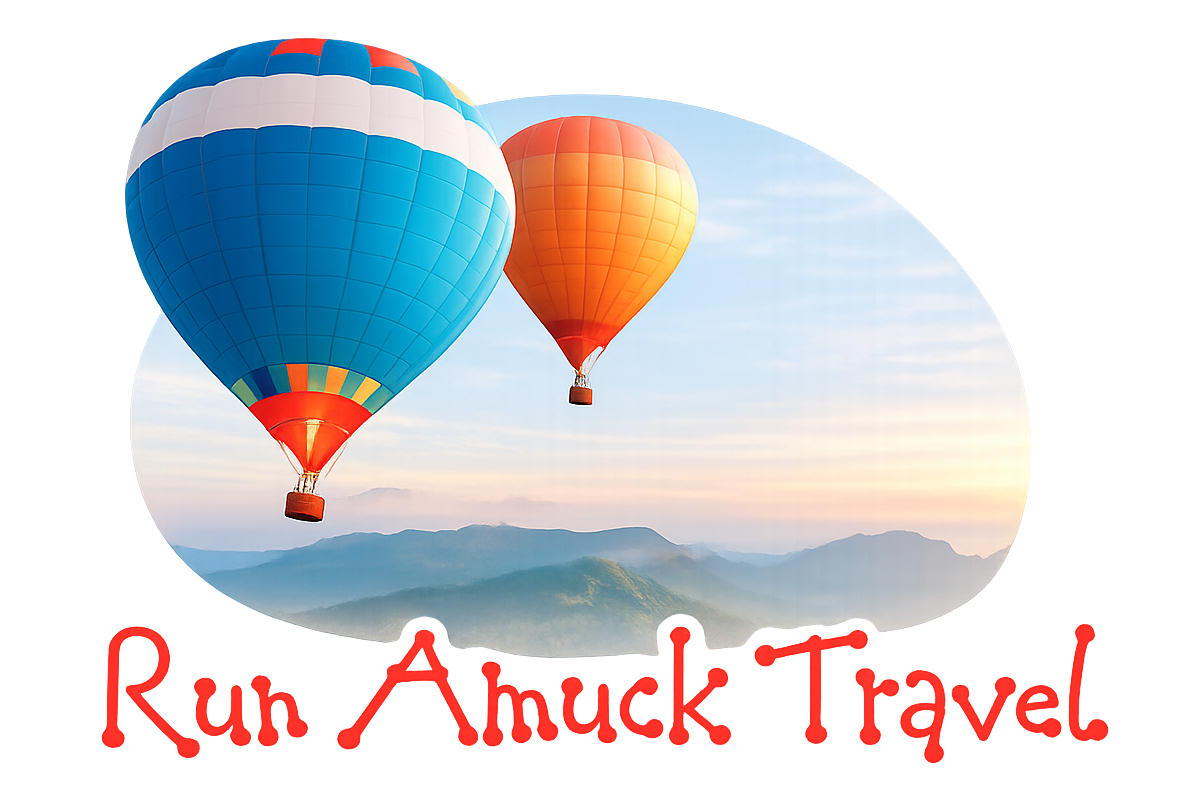 Two colorful hot air balloons above mountains with the text “Run Amuck Travel”