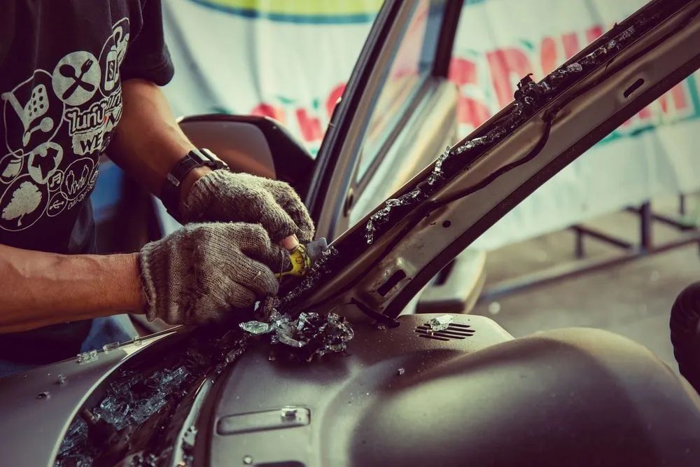 Person Wearing Gloves Repairing a Car Windshield — Southern Tablelands Windscreen Repairs in Bowral, NSW