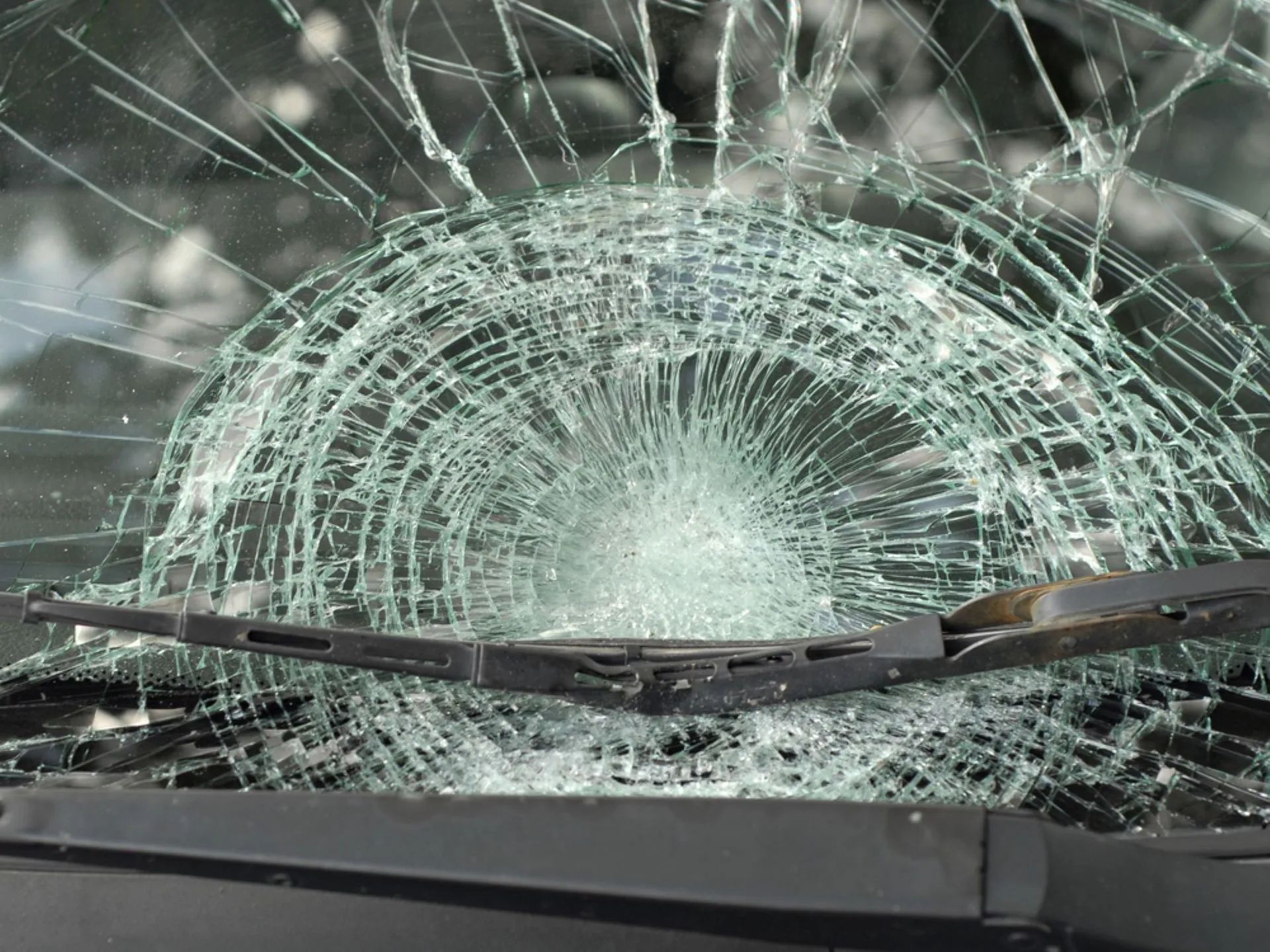 Shattered Car Windshield With Wiper Blades — Southern Tablelands Windscreen Repairs in Taralga, NSW