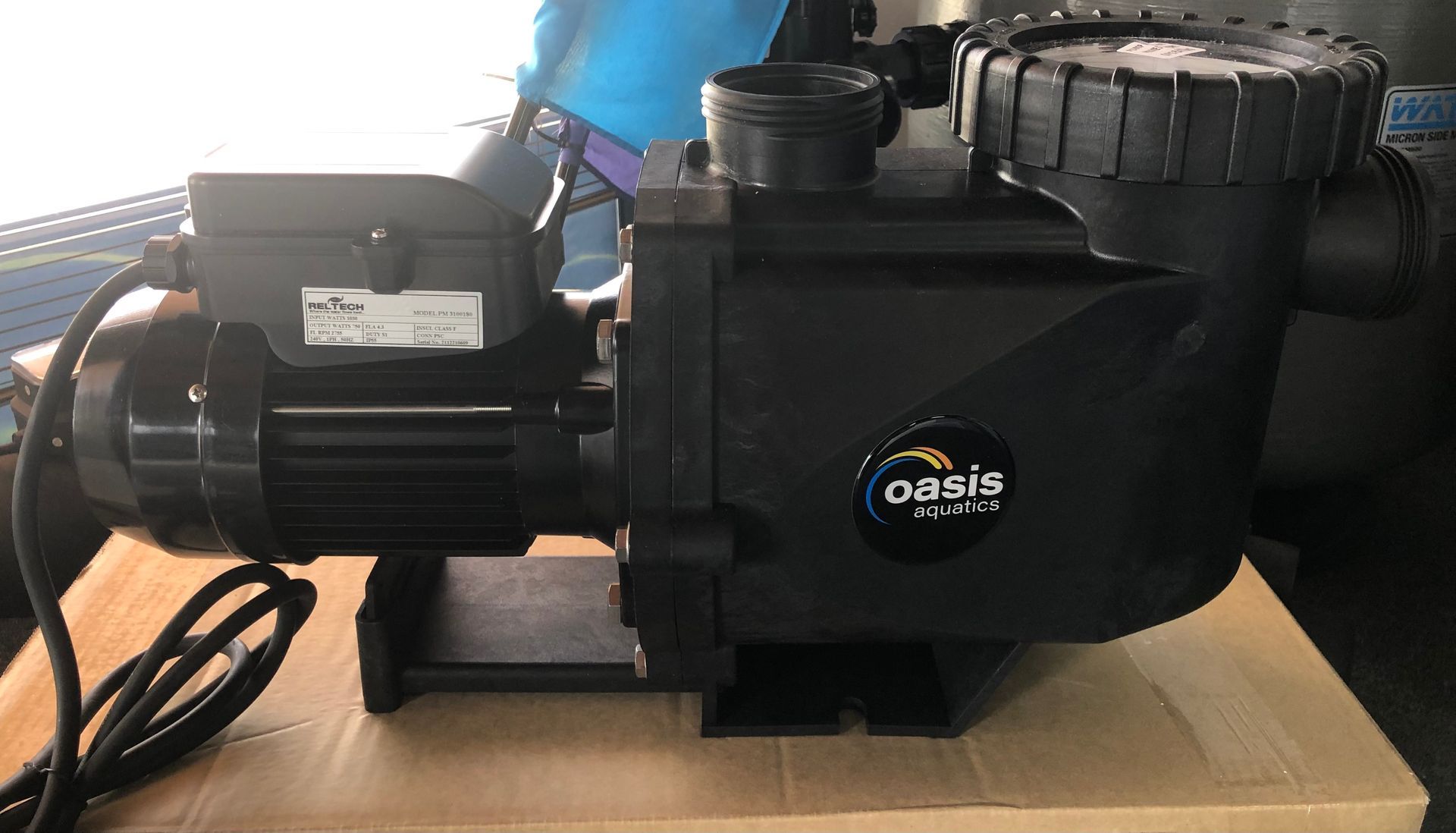 Black Oasis pool pump on a cardboard surface — Tweed Pool Shop in Tweed Heads South, NSW