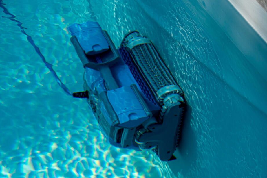 A Robotic Vacuum Cleaner is Cleaning the Side of a Swimming Pool — Tweed Pool Shop in Tweed Heads South, NSW