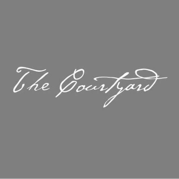 A gray background with the words the courtyard written in white