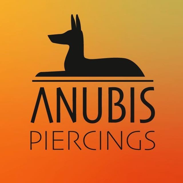 A logo for anubis piercings with a dog on it