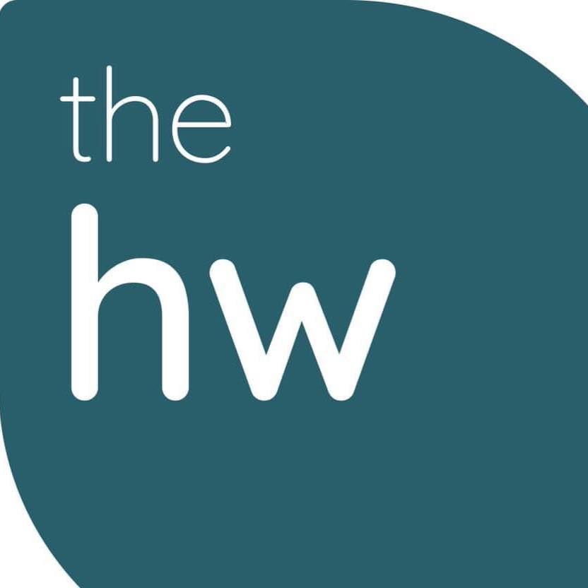 The logo for the hw is a blue circle with white letters on it.