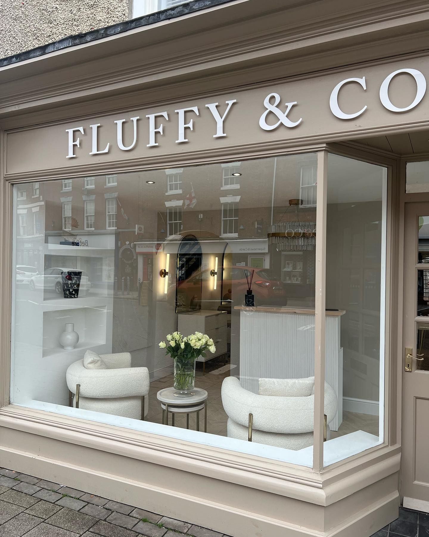 The front of a fluffy & co. store with a large window