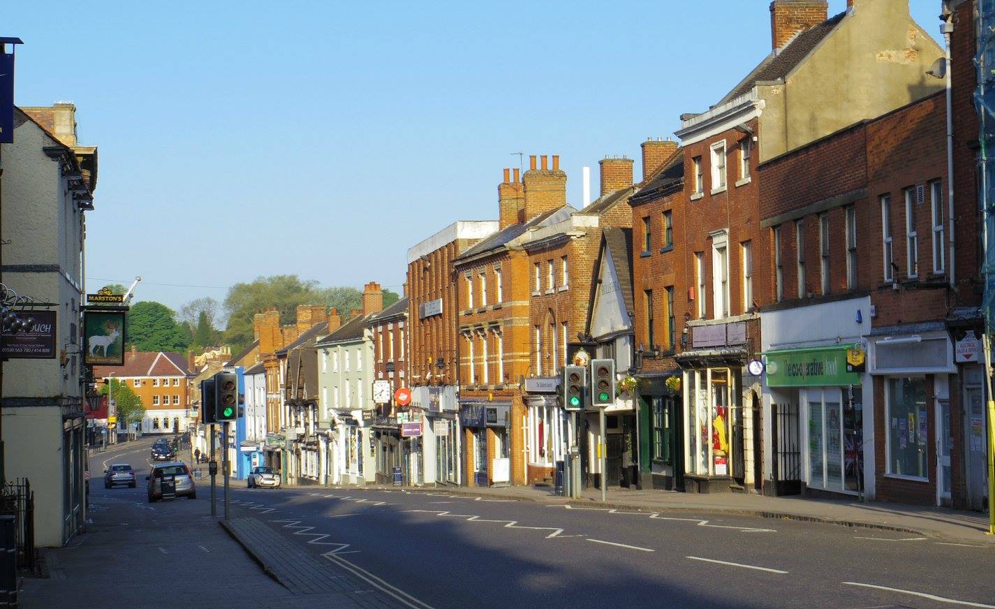 A row of brick buildings along a street in a small town