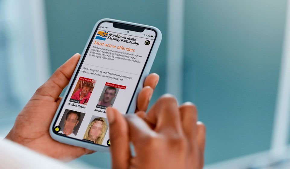 A person is holding a cell phone in their hand.