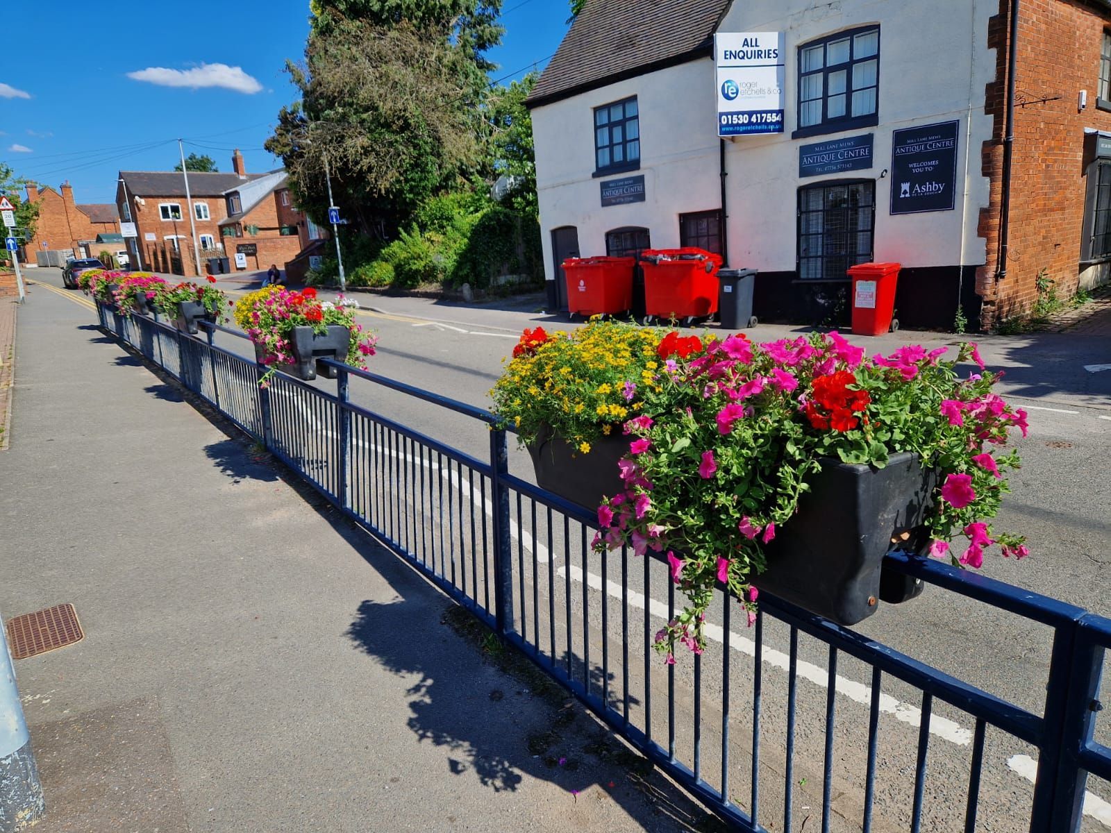 A fence with flowers on it in front of a building