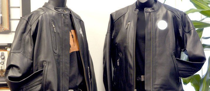 Two black leather jackets are sitting next to each other on a mannequin.