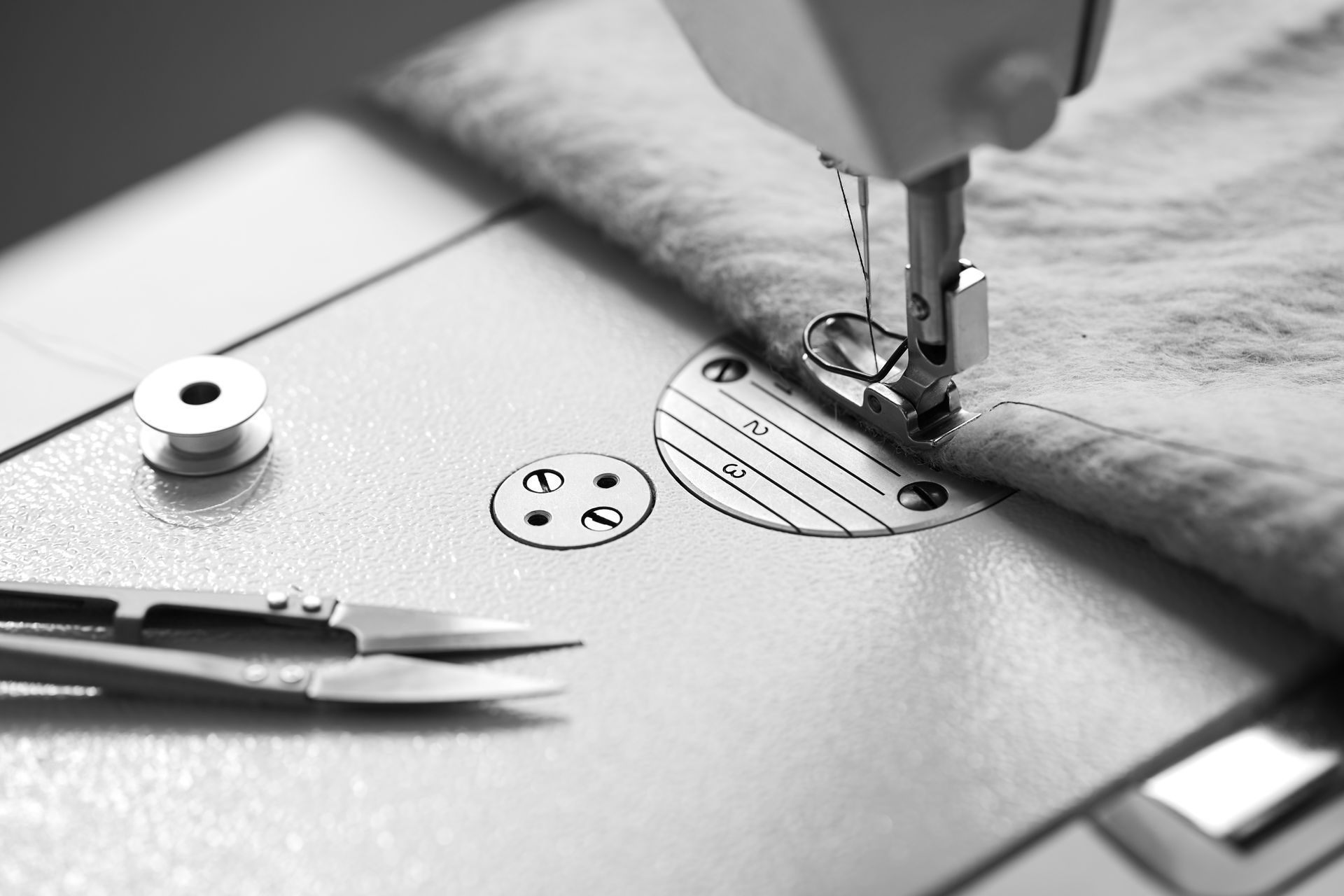A black and white photo of a sewing machine
