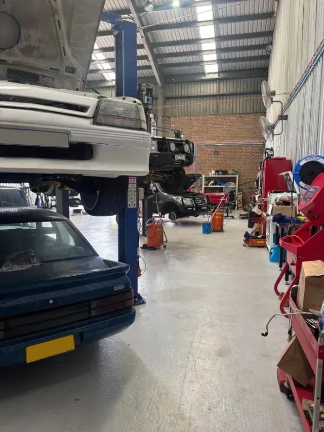 Cars on Lifts in A Garage Shop — Level Up Automotive In Unanderra, NSW