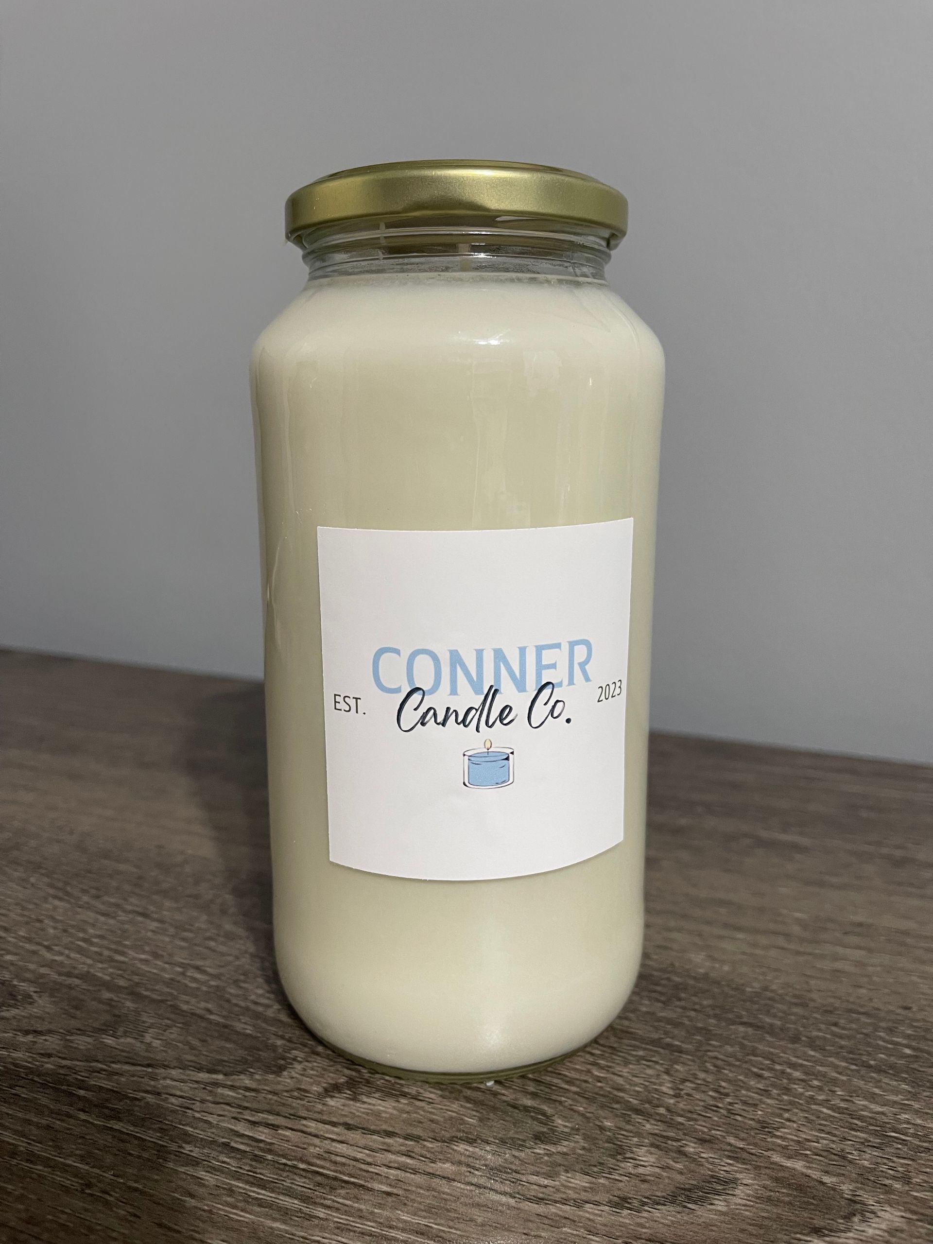Jar of white liquid with a label that says "CONNER at Candle Co. Jar."