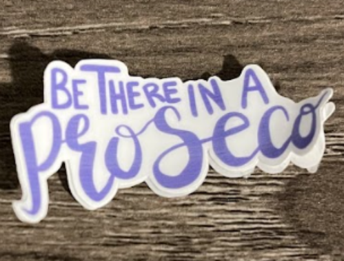 Purple and white sticker: "Be there in a Prosecco" in cursive font.
