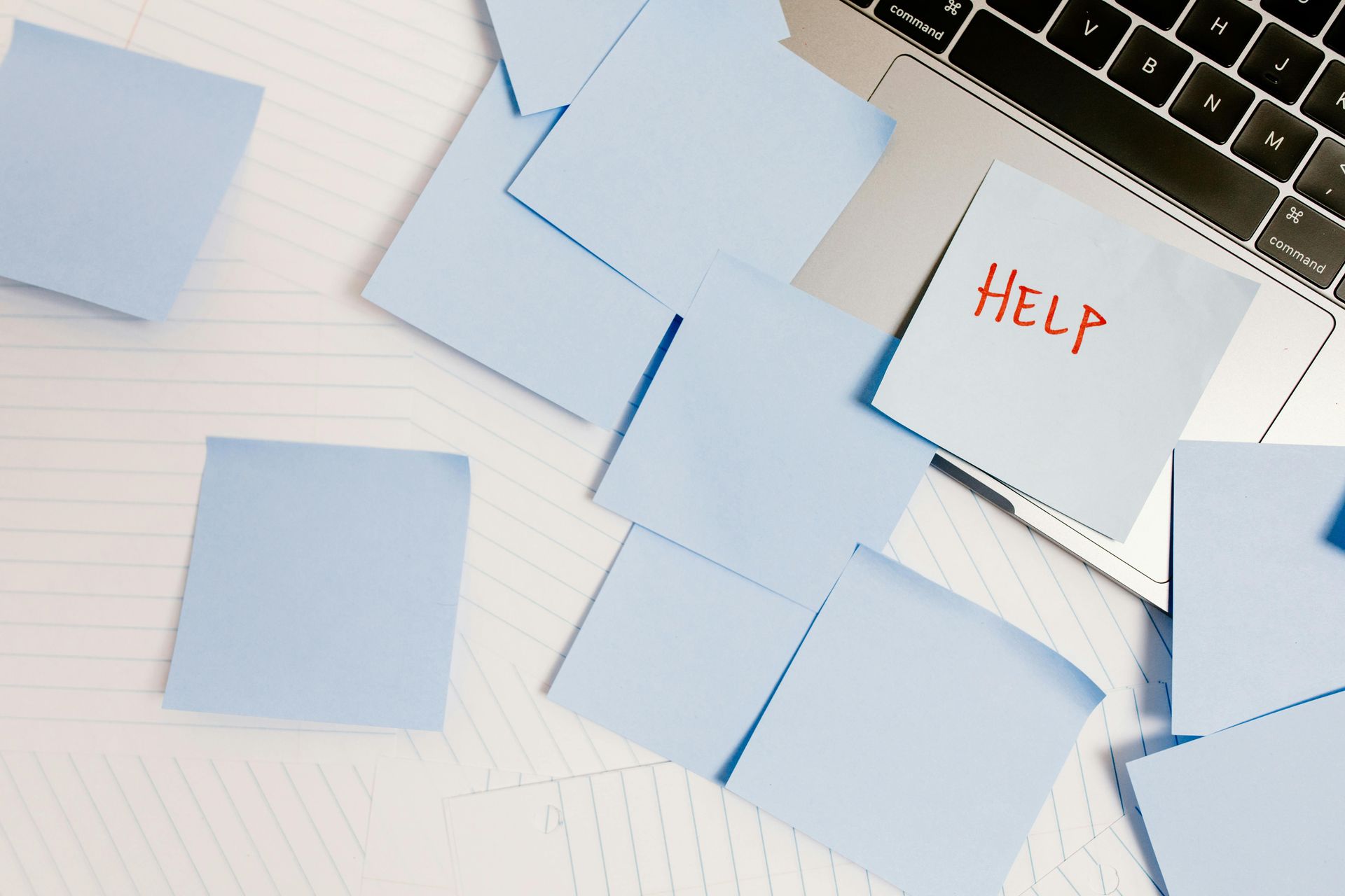 Blue sticky notes scattered on a white surface, one with 