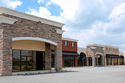 A row of commercial buildings with a lot of windows and awnings.