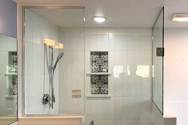 A bathroom with a walk in shower and a bathtub.