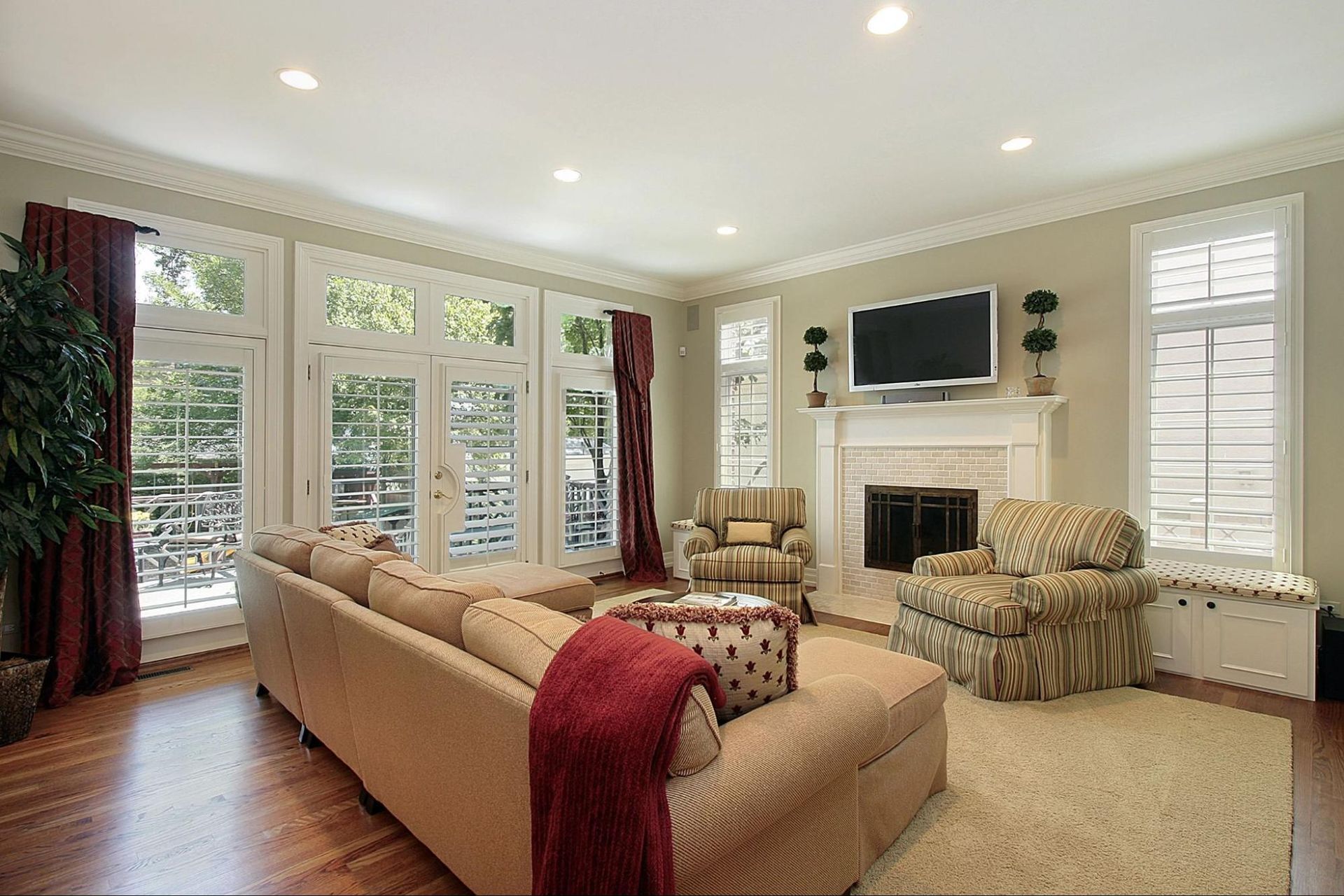 A living room with a large couch and a flat screen tv