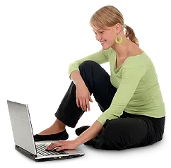 A woman is sitting on the floor using a laptop computer A woman is sitting on the floor using a laptop computer