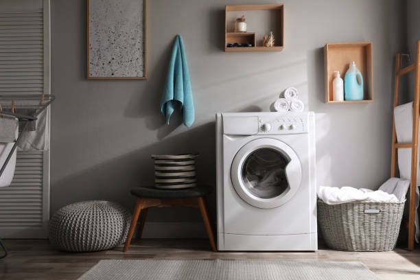 A Laundry Room With a Washer and Dryer and Baskets — Custombuilt Furnishers in Svensson Heights, QLD