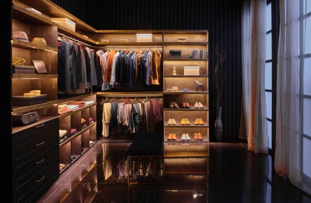 A Walk in Closet With Lots of Clothes and Shoes — Custombuilt Furnishers in Svensson Heights, QLD