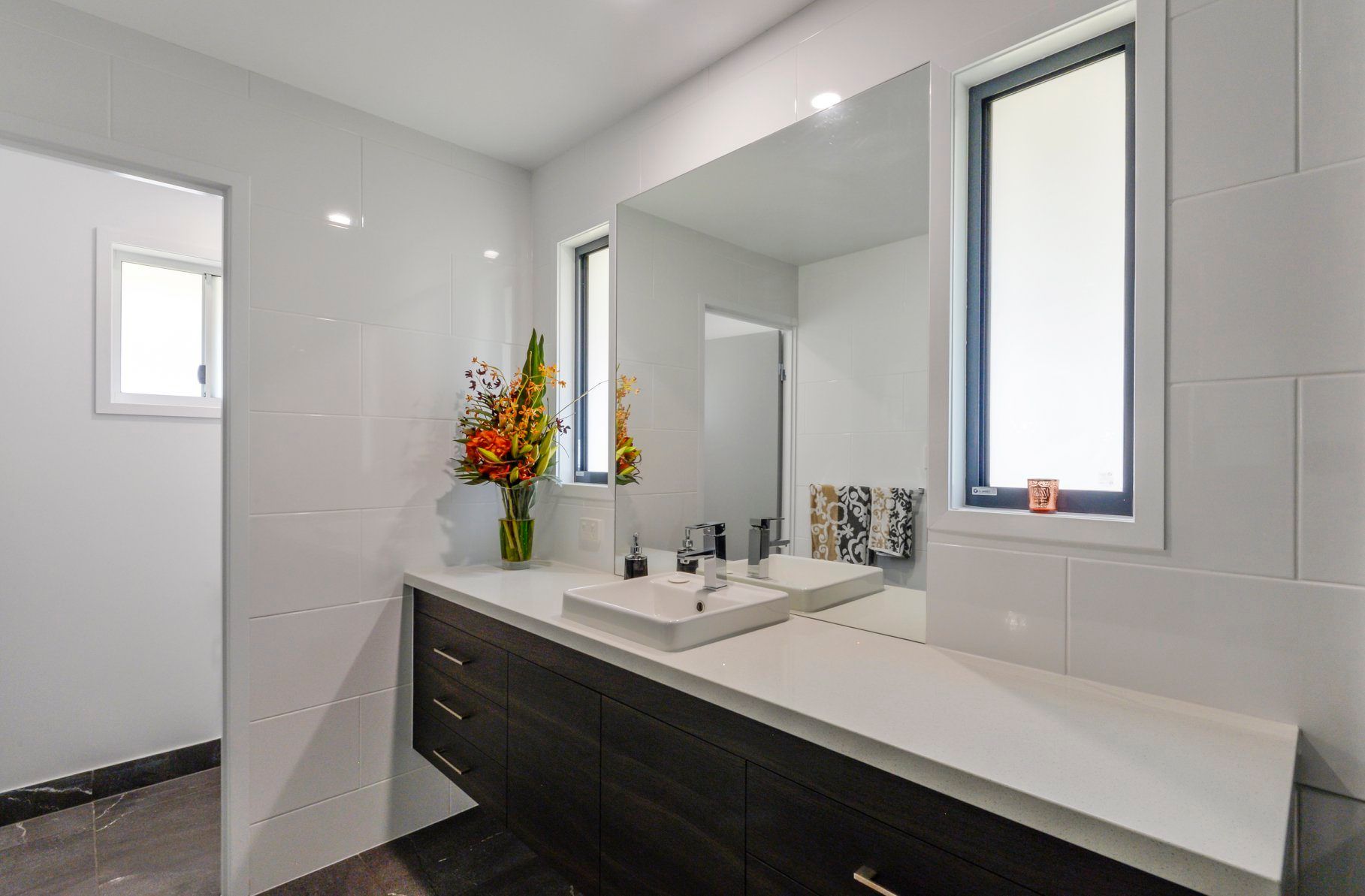 A Bathroom With Two Sinks and a Large Mirror — Custombuilt Furnishers in Svensson Heights, QLD