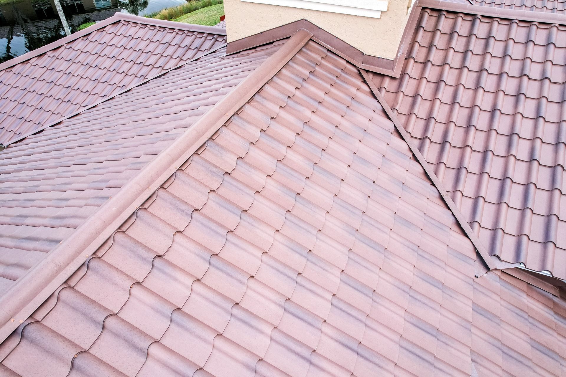 Brown tile roof with visible ridges and valley detailing.