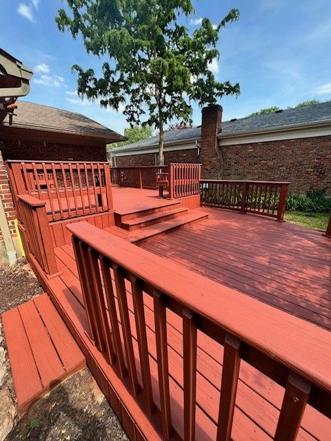 A red deck with stairs and a tree in the background - Bourbon City Softwash - Louisville, KY