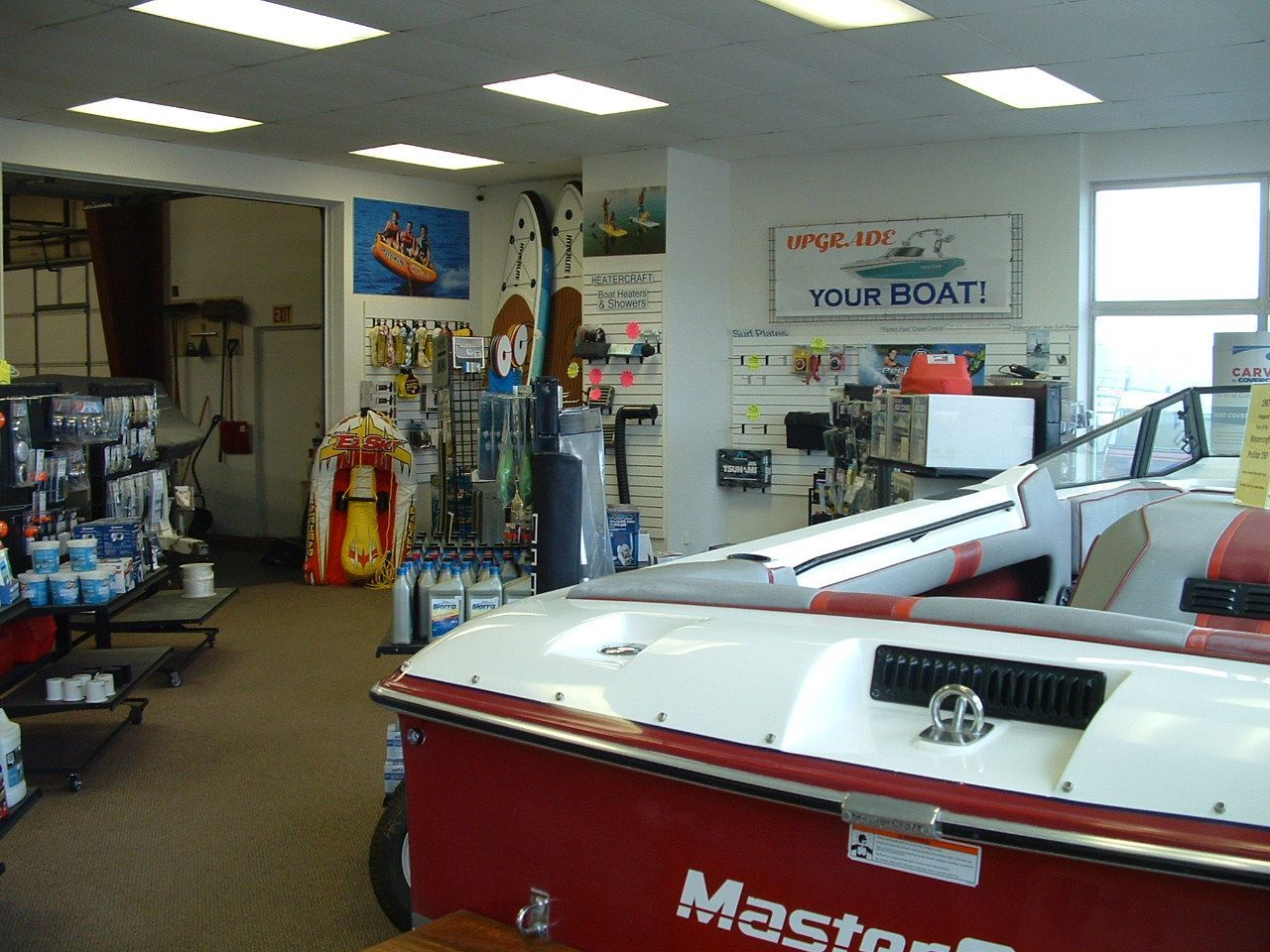 A red and white boat with the word master on the back