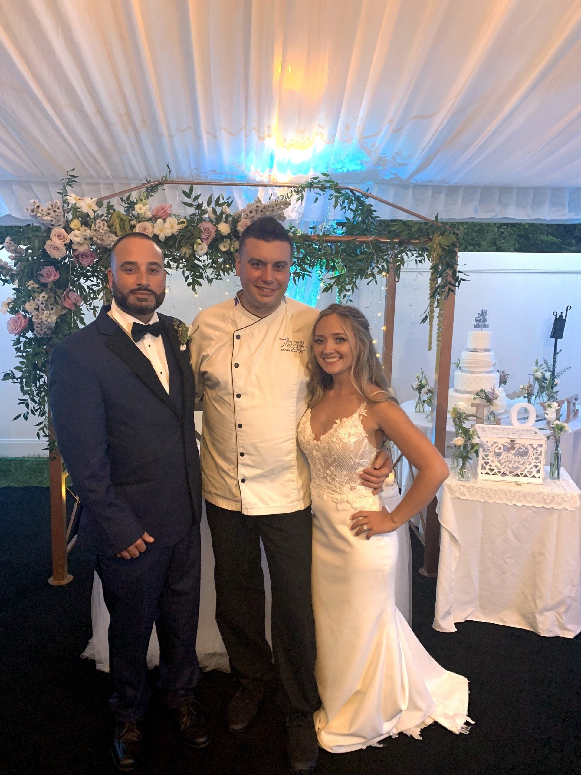 Chef posing with the bride and groom