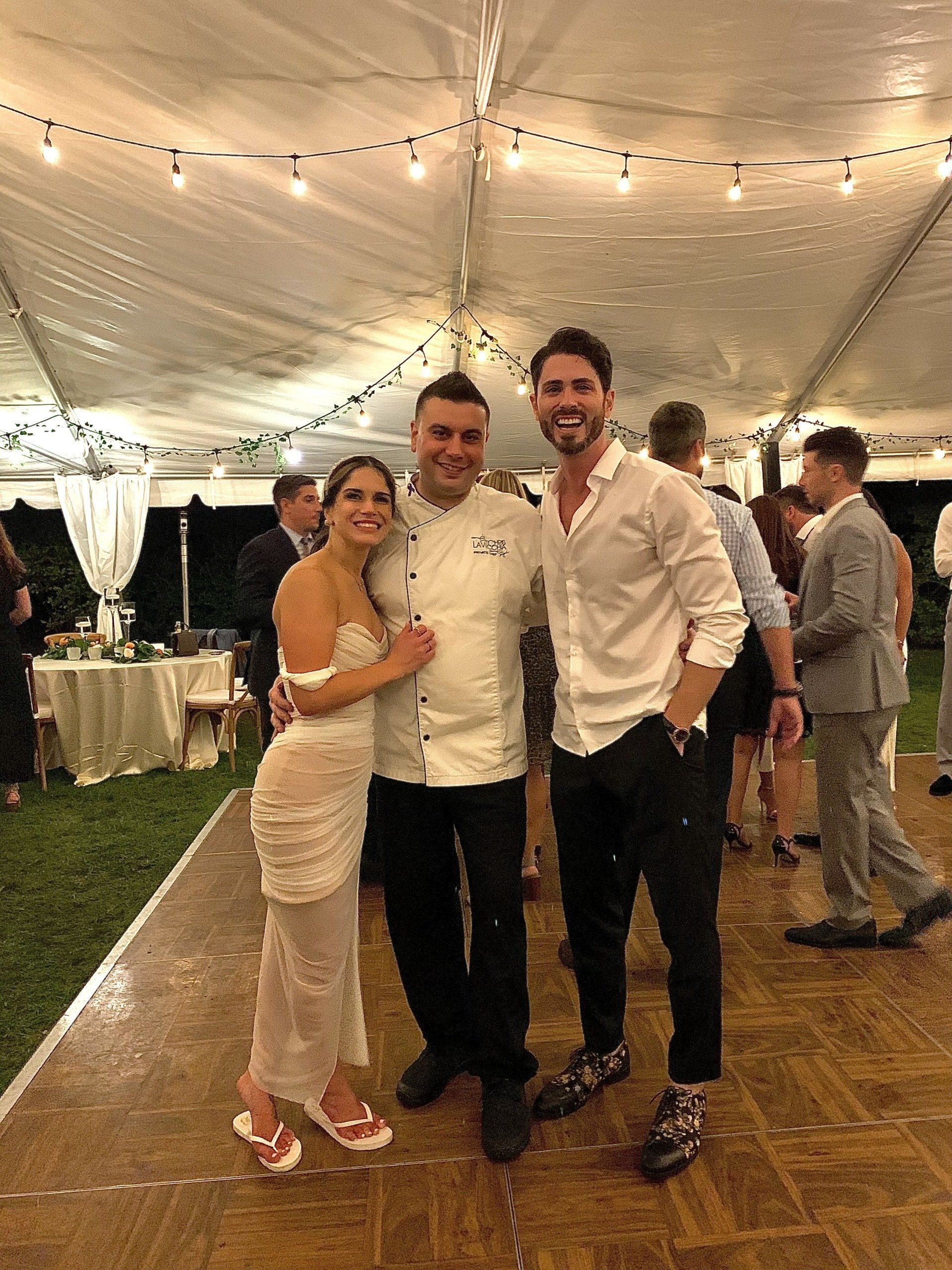 Chef posing with the bride and groom