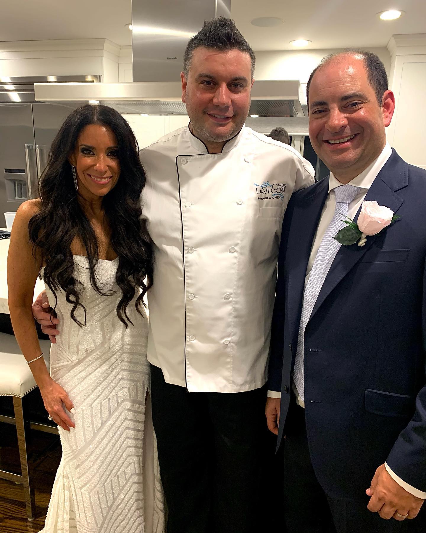 Chef posing with the bride and groom