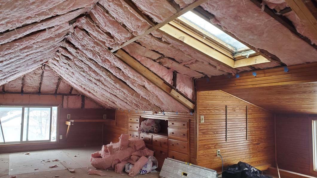 A room with a skylight and a lot of insulation on the ceiling.