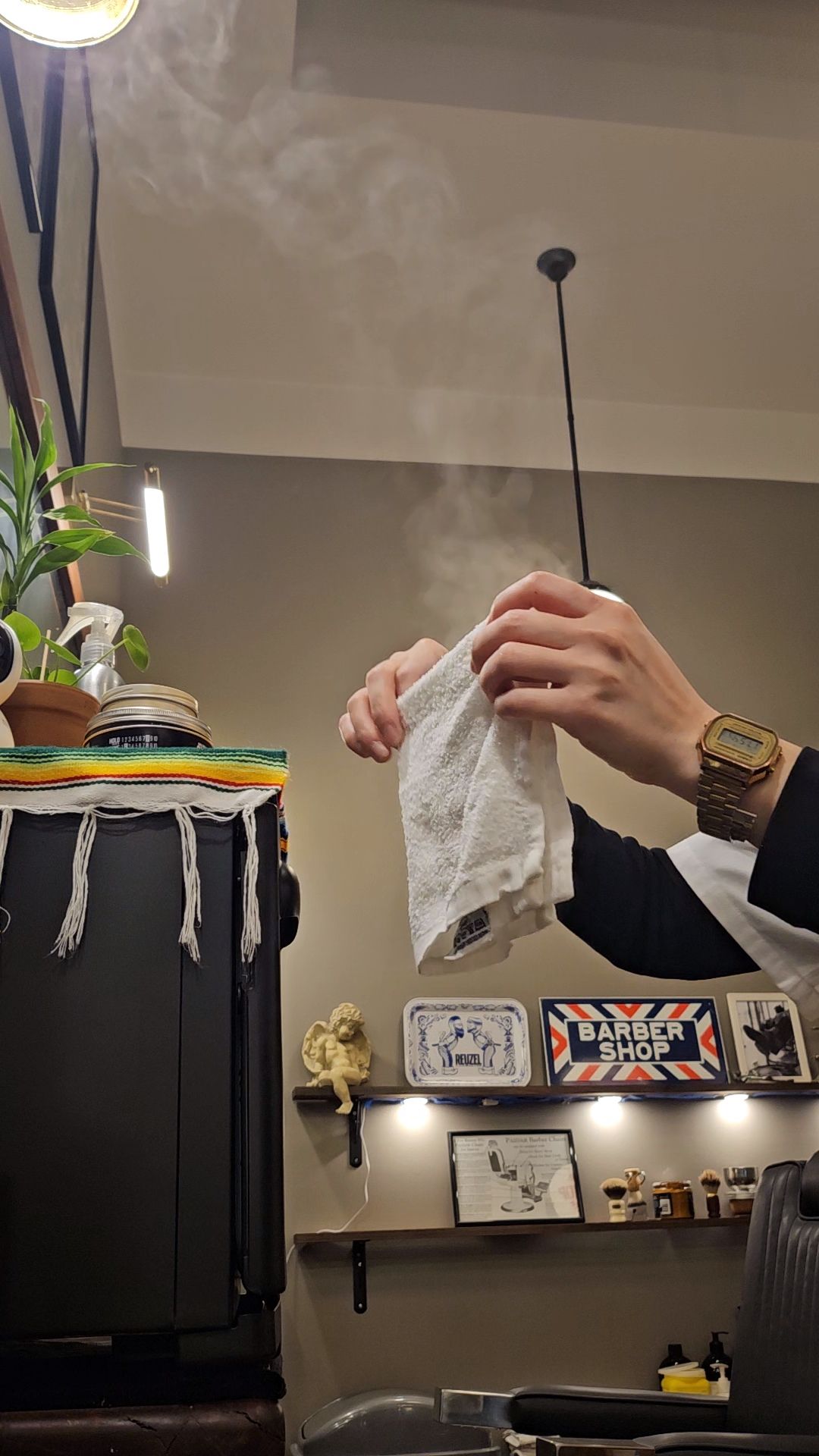 Person Holding Up a Hot Towel — Lucky Child Barber Shop In Hobart, TAS