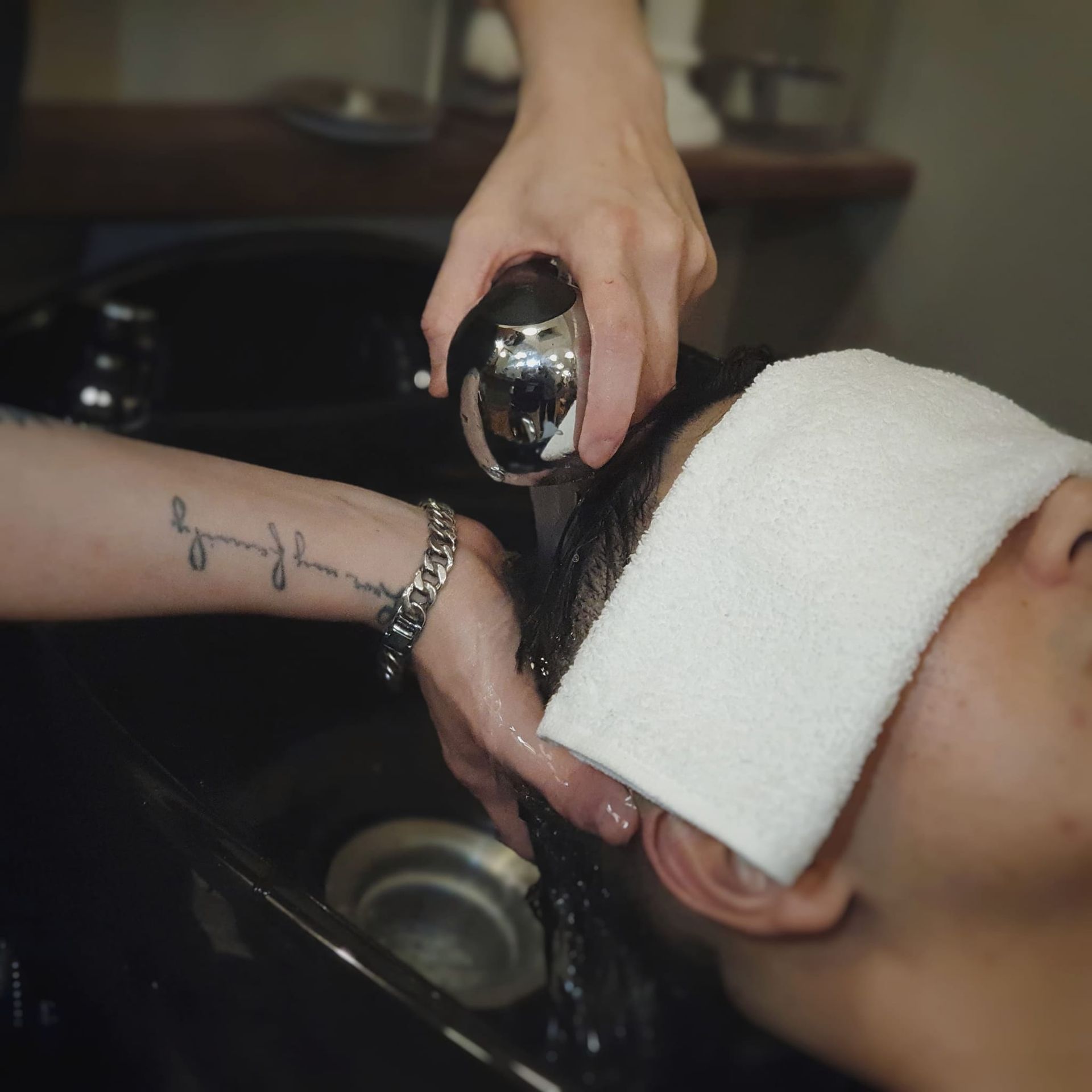 Hair Wash at a Salon Sink, With a Stylist Rinsing a Client’s Hair — Lucky Child Barber Shop In Hobart, TAS