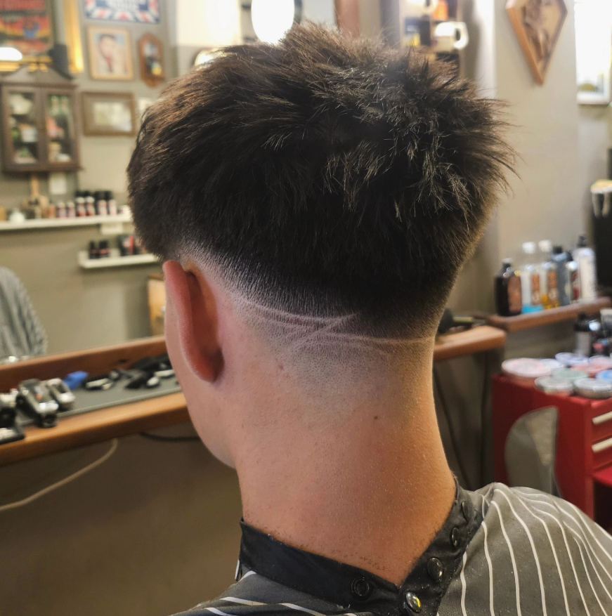 Back of a Person With a Sharp Fade Haircut in a Barbershop Chair — Lucky Child Barber Shop In Hobart, TAS
